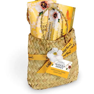 Woven basket with Manuka Honey products on a white background